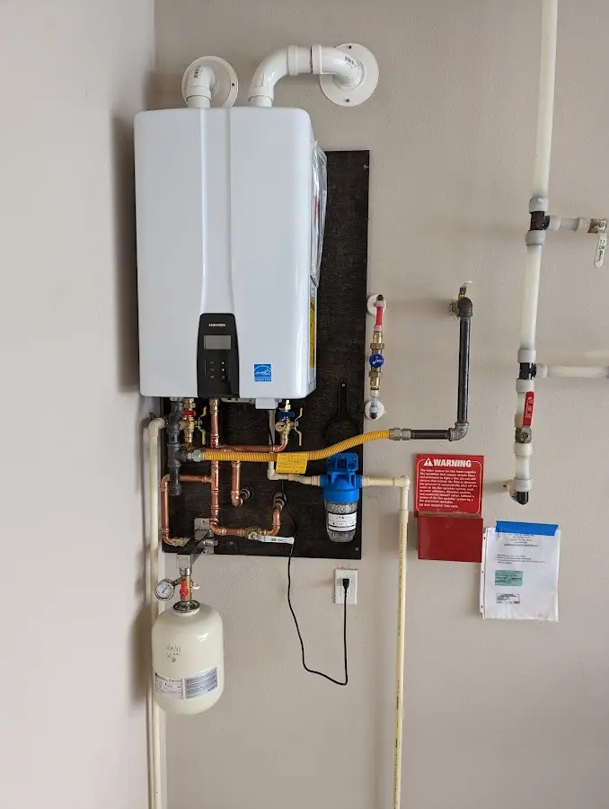 Professional plumber installing copper piping in a Thomasville home